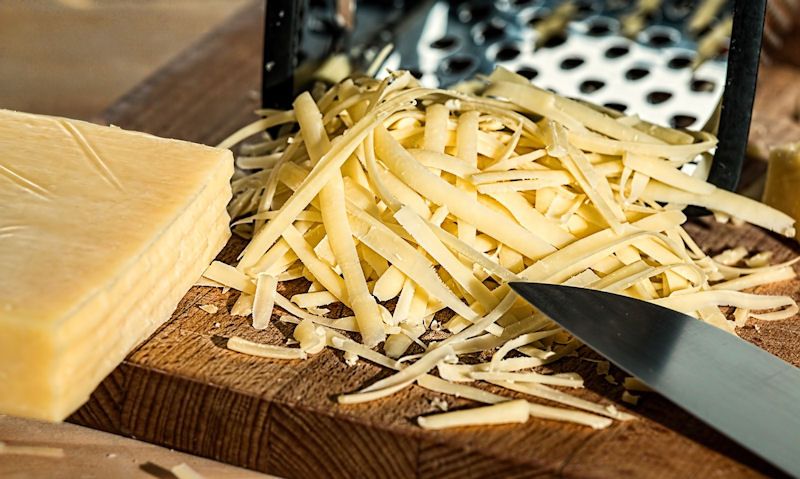 Grated cheese on chopping board