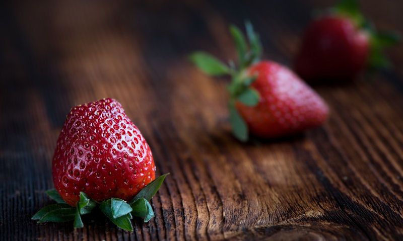 Loose strawberries on chopping board